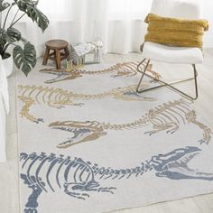 a living room area with a rug and chair in front of a large window that has a dinosaur skeleton on it