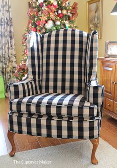 a black and white checkered chair in front of a christmas tree