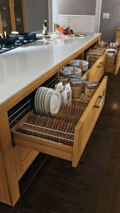 an open drawer in the middle of a kitchen counter