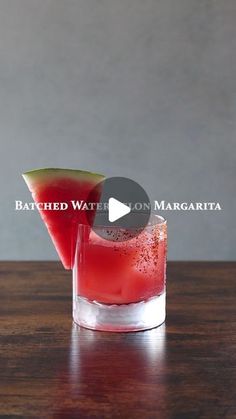 two glasses filled with watermelon sitting on top of a wooden table next to each other