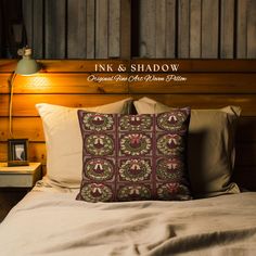 a bed with two pillows on it and a wooden headboard behind the bedspread