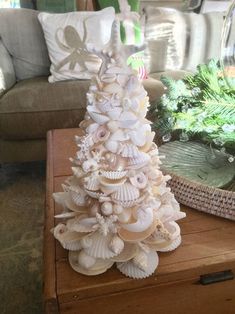 a christmas tree made out of seashells on a table