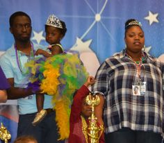 a group of people standing next to each other in front of a blue wall with stars on it