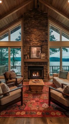 a living room with two couches and a fire place in the middle of it