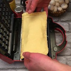 someone is making a pie in a pan with a pastry crust on the bottom and another person's hand reaching for it