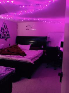 a bed room with a neatly made bed and purple lights on the ceiling above it