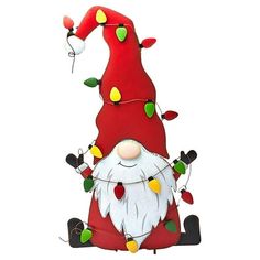 a red santa clause sitting on top of a christmas tree with lights around his feet