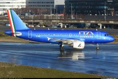 an airplane is sitting on the tarmac in front of some buildings