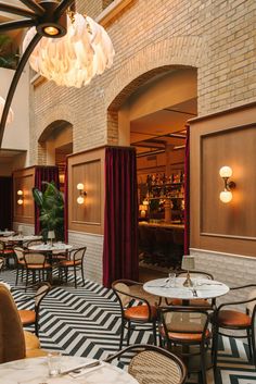 the inside of a restaurant with tables and chairs