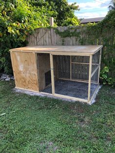 a dog house made out of pallets in the yard