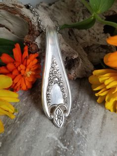 a close up of a spoon on a table with flowers