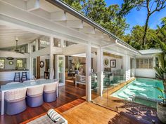 an outdoor living area with pool and hot tub