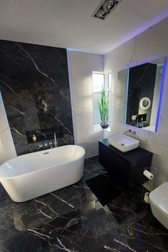 a bathroom with black marble floors and walls