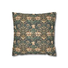 a blue and green pillow with an ornate design on it's back side, in front of a white background