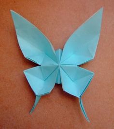 an origami butterfly sitting on top of a table