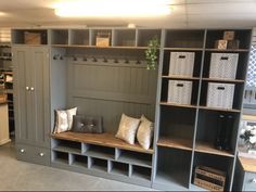 a room filled with lots of gray shelves and white baskets on top of each shelf