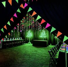 an image of a party setting with neon lights and trees on the wall in the background