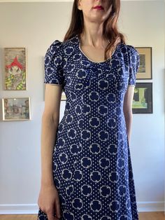 This body skimming vintage 70s geometric maxi dress is divine. So So Vampires Wife (style) with nods to prairie and cult dresses.  * Navy Blue & White, geometric print  70s vintage maxi / prairie dress  * Tie waist gives a lovely fit and the lightweight fabric skims the body  * Sweetheart neckline with white piping detail (and at sleeve hems)  * Concealed zip @ back  * Original Vintage Labels attached  Excellent condition some very minor yellowing on the neck and arm piping, expected with age. T Fitted Square Neck Lined Maxi Dress, Fitted Patterned Maxi Dress With Short Sleeves, Fitted Short Sleeve Patterned Maxi Dress, Fitted Vintage Print Dress Inspired By 70s, Fitted Dress With Vintage Print In 70s Style, Fitted 70s Inspired Dress With Vintage Print, Printed Fitted Maxi Dress With Square Neck, Retro Fitted Square Neck Dress, Retro A-line Vintage Dress With Vintage Print