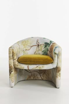 an upholstered chair with a yellow cushion