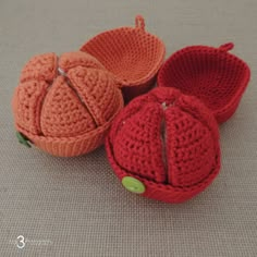 three crocheted pumpkins sitting next to each other