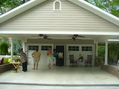 three people standing in front of a garage