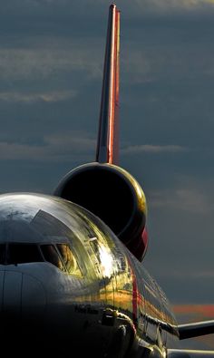 the tail end of an airplane as it sits on the tarmac