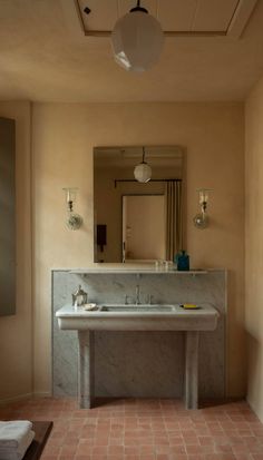 a bathroom sink sitting under a mirror next to a window