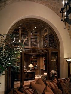 a living room filled with lots of furniture and a chandelier hanging from the ceiling