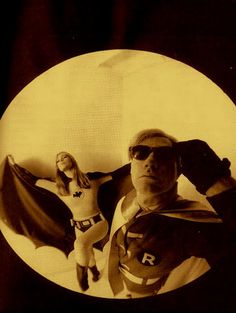 an old photo of two people dressed as superheros