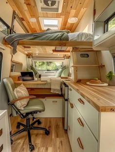 an interior view of a camper with bunk beds and desk in the foreground