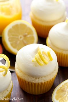 cupcakes with icing and lemon slices on a table