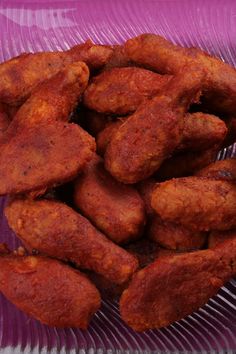 some fried food is on a purple plate