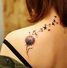 a woman with a dandelion tattoo on her back