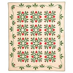 a quilt with red flowers and green leaves on it