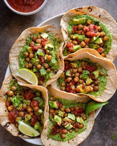 three tortillas filled with guacamole, salsa and avocado