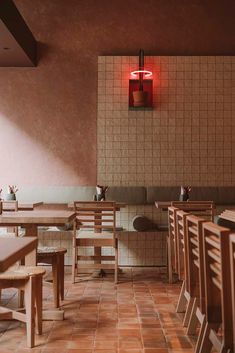 an empty restaurant with wooden tables and chairs