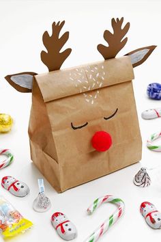 a brown paper bag with reindeer noses and candy canes