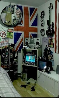 a room filled with guitars and other musical instruments on the wall next to a bed