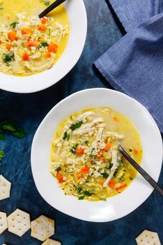 two bowls of chicken and rice soup with crackers