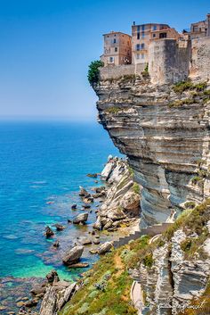 an old castle perched on top of a cliff overlooking the ocean