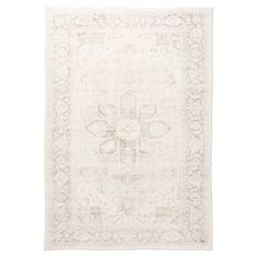 a white rug with an ornate design on it