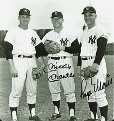 three baseball players posing for a photo in their uniforms with signed hats and mitts