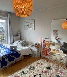 a bed room with a neatly made bed and a laptop