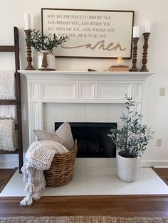 a living room with a white fireplace and some plants on top of the mantel