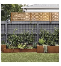 a fenced in garden area with various types of plants