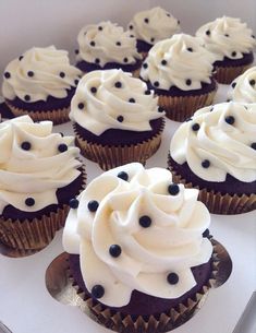 cupcakes with white frosting and black sprinkles