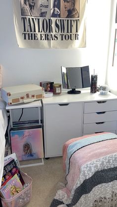 a bedroom with a bed, desk and dresser