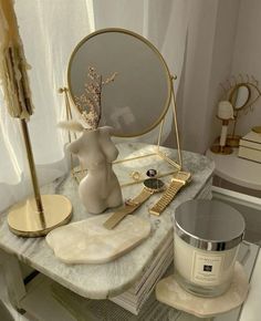 a table topped with a mirror and other items