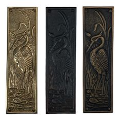 three metal plaques with birds on them in different colors and sizes, one is gold, the other is black