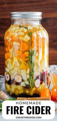 homemade fire cider recipe in a mason jar with fresh fruit and herbs on the side